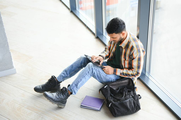 Happy indian male student at the university. - 写真・画像