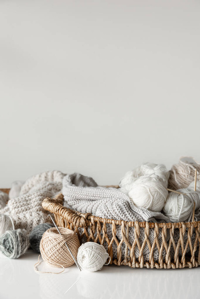 Basket with yarn close-up, pastel color threads for knitting on a blurred white background. - Photo, Image