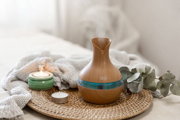 Cozy spa composition with aroma oil diffuser lamp on a blurred background. - Photo, Image