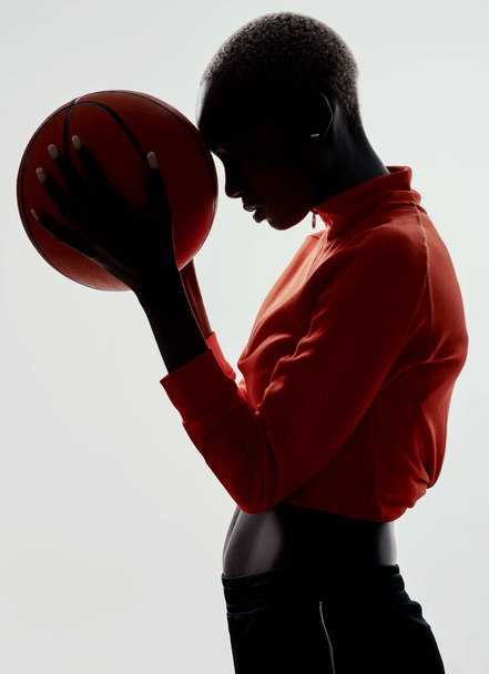 For the love of basketball. Studio shot of an attractive young woman playing basketball against a grey background - Photo, image