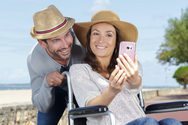a disable romantic couple taking a picture - Foto, Imagen