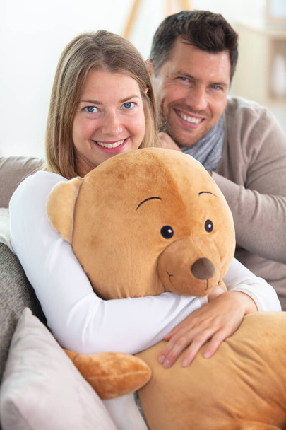happy couple with a big teddy bear - Zdjęcie, obraz