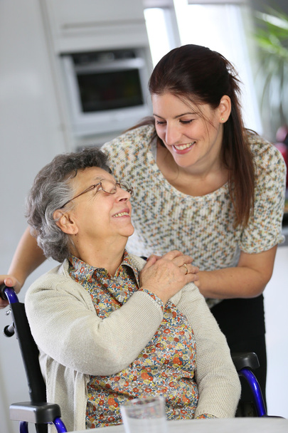 Woman in wheelchair with home carer - Foto, immagini