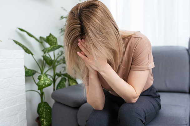 Sad tired young woman touching forehead having headache migraine or depression, upset frustrated girl troubled with problem feel stressed cover crying face with hand suffer from grief sorrow concept - Photo, Image