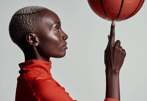 Embrace your talent, itll take you to the top. Studio shot of an attractive young woman playing basketball against a grey background - Foto, Bild