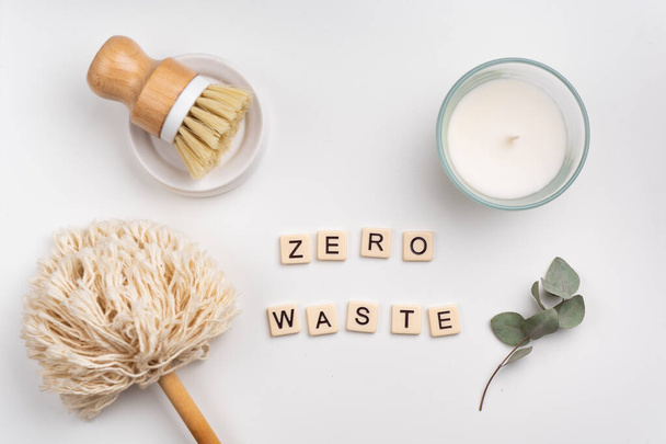 sustainable lifestyle concept flat lay with bamboo brush, dusting brush and candle. phrase ZERO WASTE written with tile letters   - Foto, afbeelding