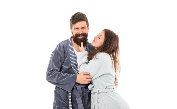 Sleepy woman touch beard of happy family man in robes isolated on white, couple. - Foto, Imagen
