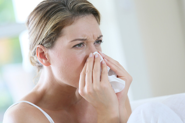 Woman with allergy blowing nose - Photo, image
