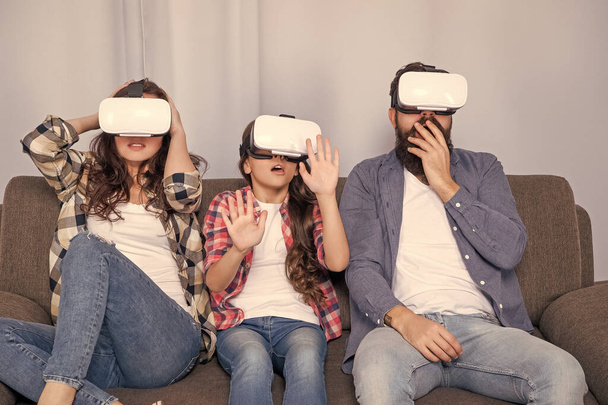 amazed parents with kid spend time together in vr glasses at home, future technology. - Foto, Imagem
