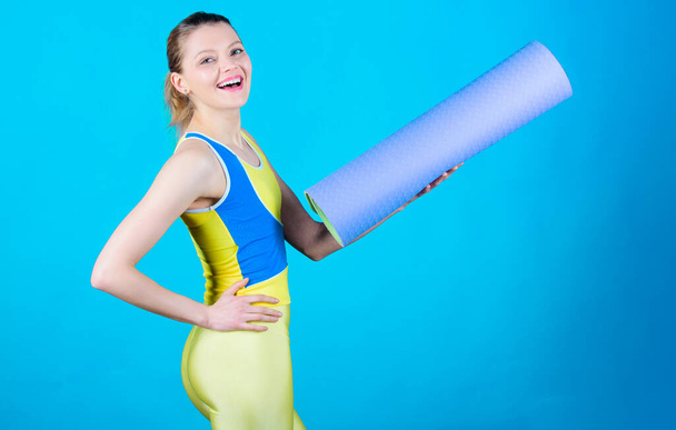 Stretching those muscles before workout. Health diet. Success. Sport mat equipment. Athletic fitness. Strong muscles and power. Happy woman workout with fitness mat. Sporty woman training in gym. - Photo, image