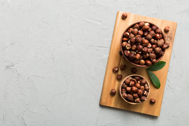 Wooden bowl full of hazelnuts on table background. Healthy eating concept. Super foods. - Photo, image