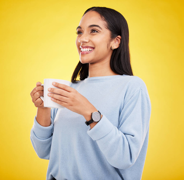 Morning, coffee mug and happy woman in a studio with a smile from espresso. Isolated, yellow background and smile of a young female with happiness and joy ready to start the day with confidence. - Fotografie, Obrázek
