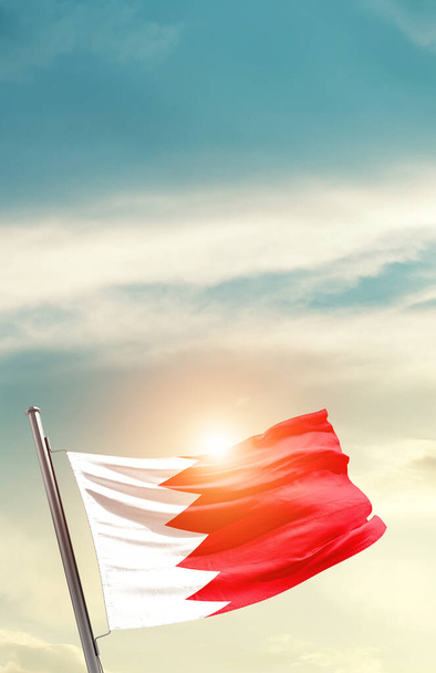 Bahrain waving flag in beautiful sky with sun - Zdjęcie, obraz