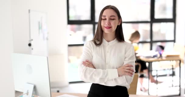 Een mooie jonge zakenvrouw lacht op kantoor. Managers werkplek, gelukkige werknemer - Video