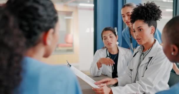 Doctors, nurse or women on clipboard in meeting, collaboration or teamwork for hospital planning, medical or surgery schedule. Talking, leadership or healthcare workers on paper in diversity research. - Felvétel, videó