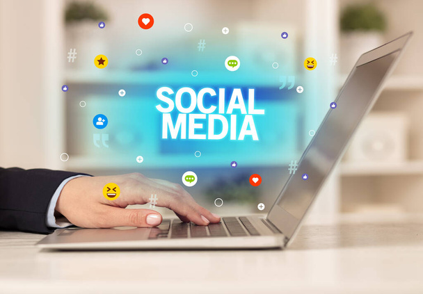 Freelance woman using laptop with SOCIAL MEDIA inscription, Social media concept - Foto, Imagem