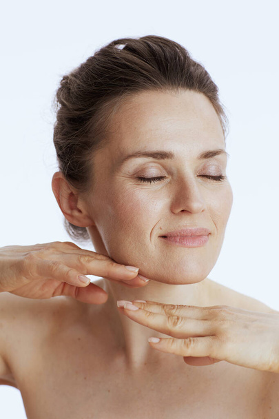 modern female doing facial massage against white background. - Фото, зображення