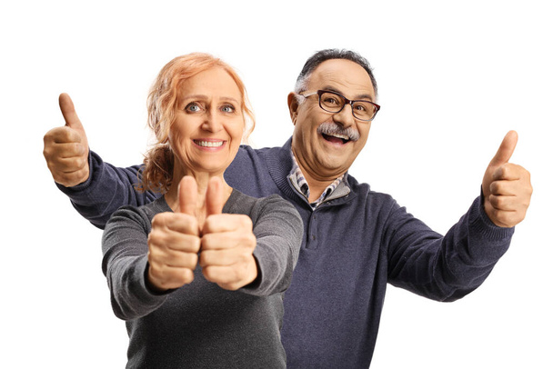 Cheerful mature man and woman gesturing thumbs up isolated on white background - Photo, Image
