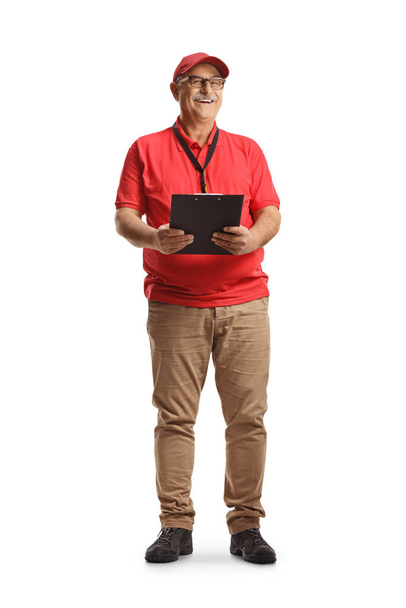 Mature male sales worker holding a clipboard isolated on white background - Φωτογραφία, εικόνα