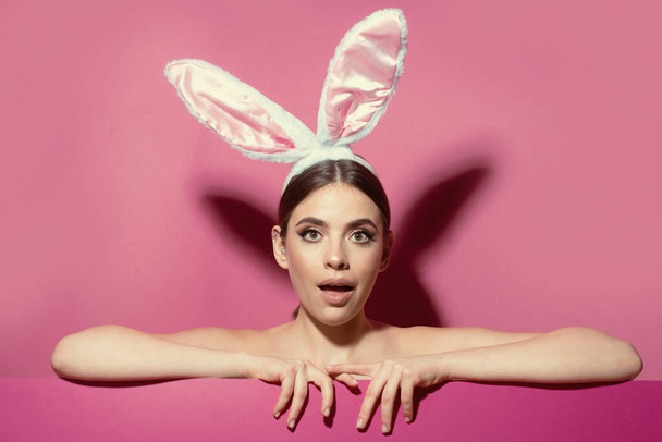 Close-up portrait of attractive lovely pretty cheerful girl wearing pink ears. Easter woman with rabbit ears - Foto, Imagen