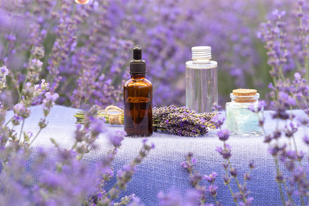 Amber essential lavender oil bottle. Violet lavendar field in Provence - Photo, Image