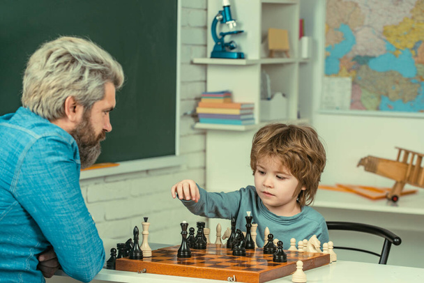Games good for brain intelligence concept. Concentrated boy developing chess strategy. Fathers day - Photo, image