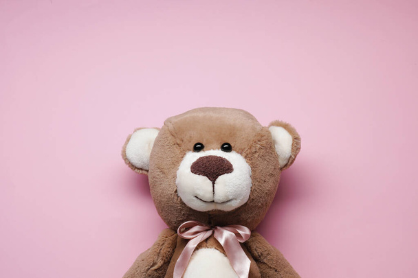 Cute teddy bear on pink background, top view - Photo, Image