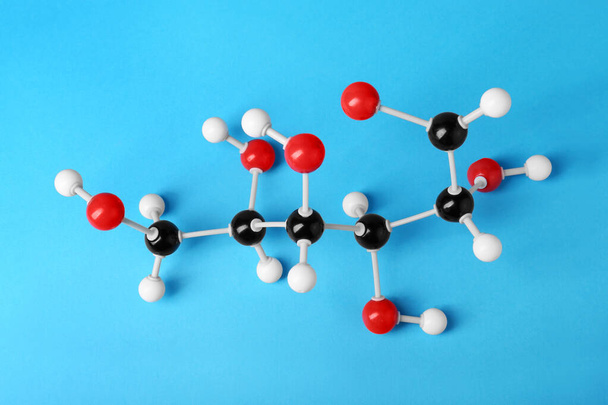 Molecule of glucose on light blue background, above view. Chemical model - Foto, imagen