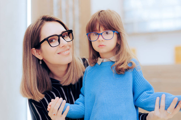 Mother and Daughter Wearing Eyeglasses in an Ophthalmology Clinic  - Fotoğraf, Görsel