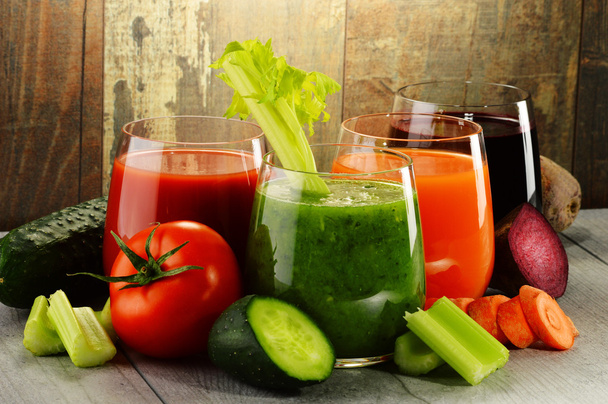Glasses with fresh organic vegetable juices on wooden table - Photo, Image