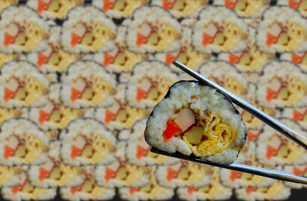 background kimbap or gimbap is Korean roll Gimbap(kimbob) made from steamed white rice (bap) and various other ingredients. - Photo, Image
