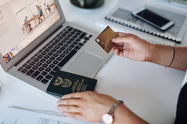 Planning and paying for my travels has never been easier. Cropped shop of an unrecognizable businesswoman using a credit card and laptop inside her laptop - Photo, Image