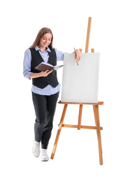 Drawing teacher with book, brush and easel on white background - Foto, afbeelding