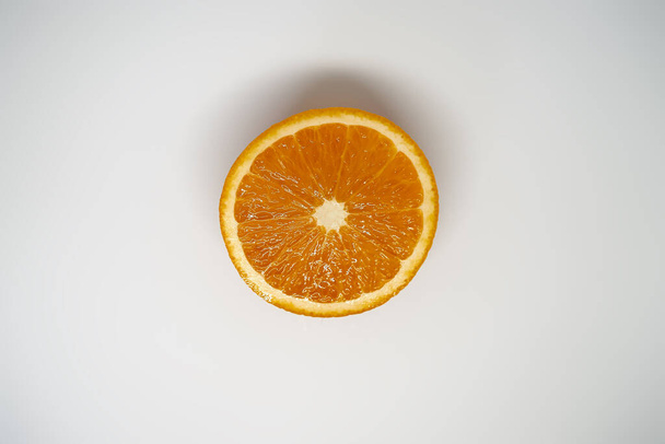 Half of an orange on a white isolated background top view - Zdjęcie, obraz