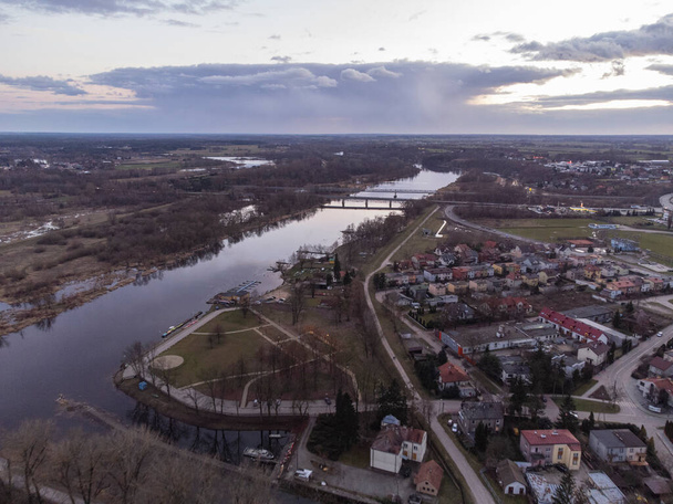 Sunset and storm clouds over the river and city on a spring day. - Fotó, kép