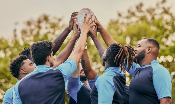 Diversity, team and men hands together in sports for support, motivation or goals outdoors. Sport group holding rugby ball in fitness, teamwork or success for match preparation or game. - Zdjęcie, obraz