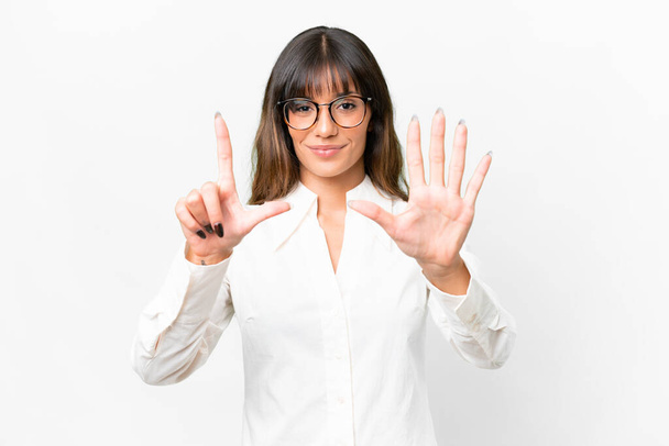 Young caucasian woman over isolated white background counting seven with fingers - Фото, изображение
