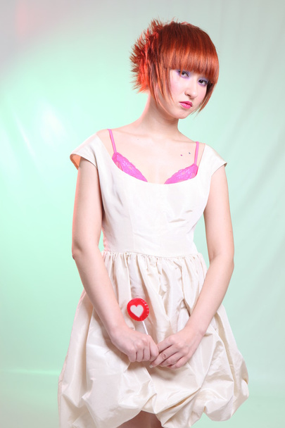 girl in satin dress with candy heart - Φωτογραφία, εικόνα