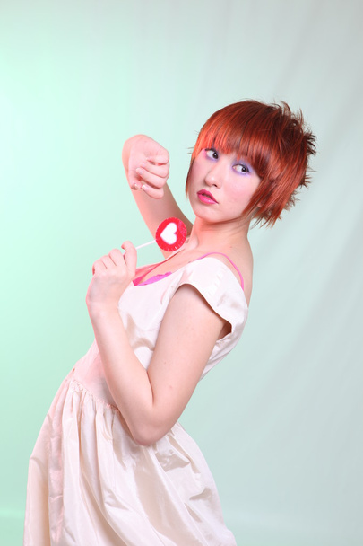 girl in satin dress with candy heart - Φωτογραφία, εικόνα