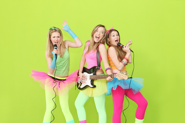 Girl band, group of girls singing and playing guitar - Foto, immagini