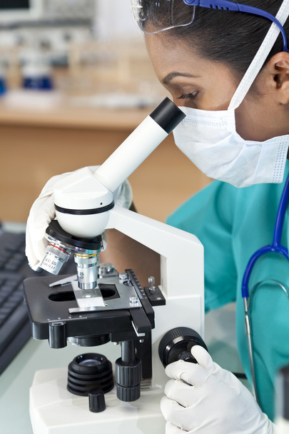 Asian Woman Doctor or Scientist Using a Microscope In Laboratory - Фото, зображення