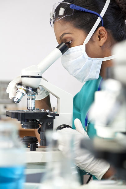 Asian Woman Doctor or Scientist Using a Microscope In Laboratory - Foto, imagen
