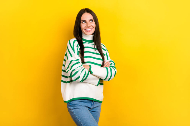 Photo of pretty adorable lady dressed striped pullover arms folded looking empty space isolated yellow color background. - Fotografie, Obrázek