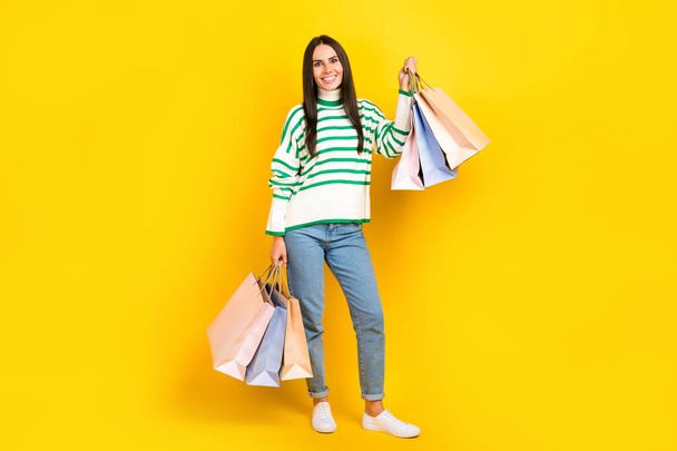 Full length photo of positive pretty lady wear nice outfit demonstrate purchase low price clothes isolated on yellow color background. - Foto, Bild
