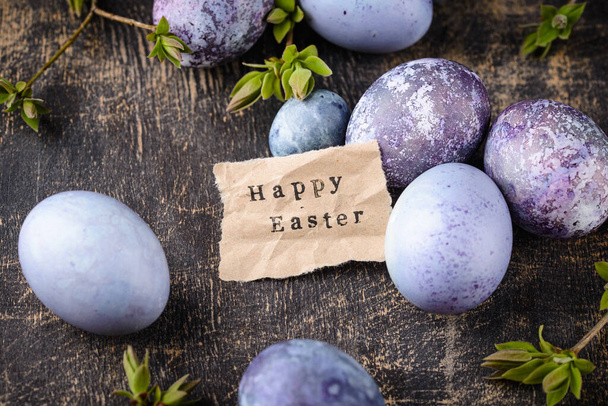Huevos de Pascua festivos pintados con té de hibisco en color púrpura y azul - Foto, Imagen