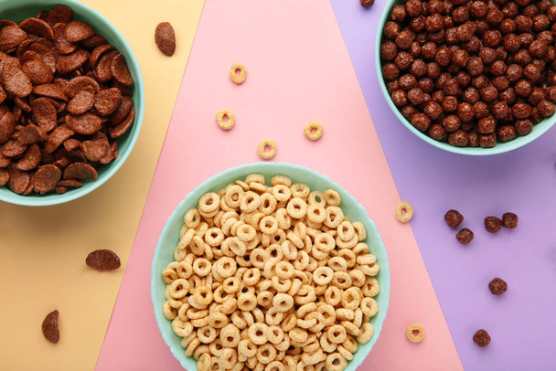 Set of various breakfast cereals on colorful background, top view - Fotó, kép