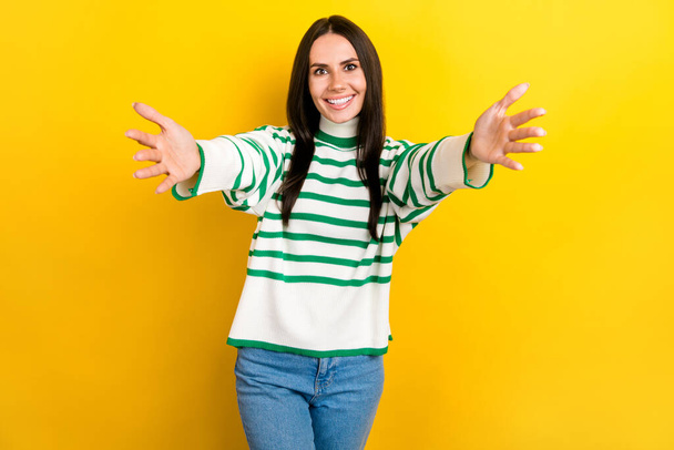 Photo of pretty excited lady dressed striped pullover open arms ready hug you isolated yellow color background. - Foto, imagen