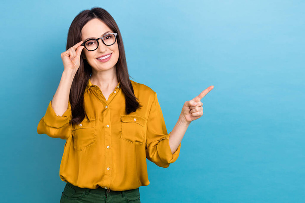 Photo of cheerful mature age business lady touch spectacles glasses pointing finger empty space proposition ad isolated on blue color background. - Photo, Image