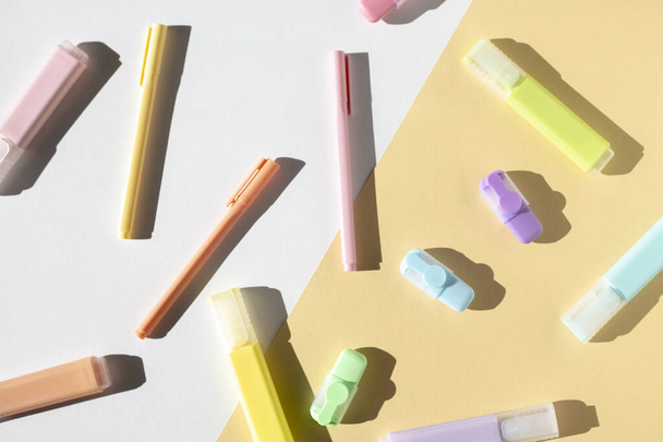 Stationery, pens, colored markers on a light background. Top view, flat lay. - 写真・画像