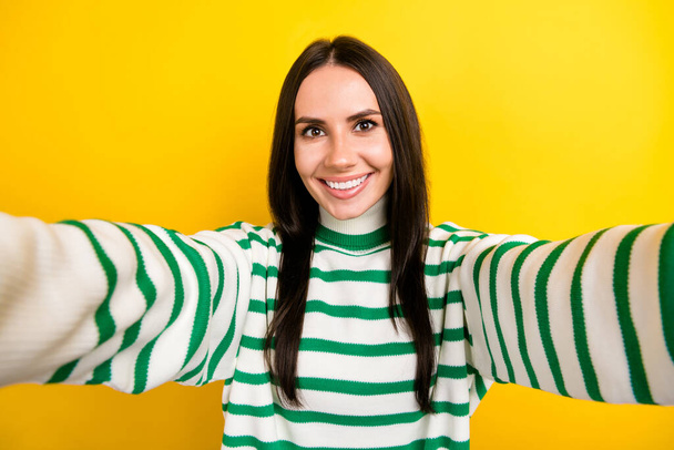 Photo of positive good mood woman wear striped sweater smiling recording video vlog isolated yellow color background. - Фото, изображение